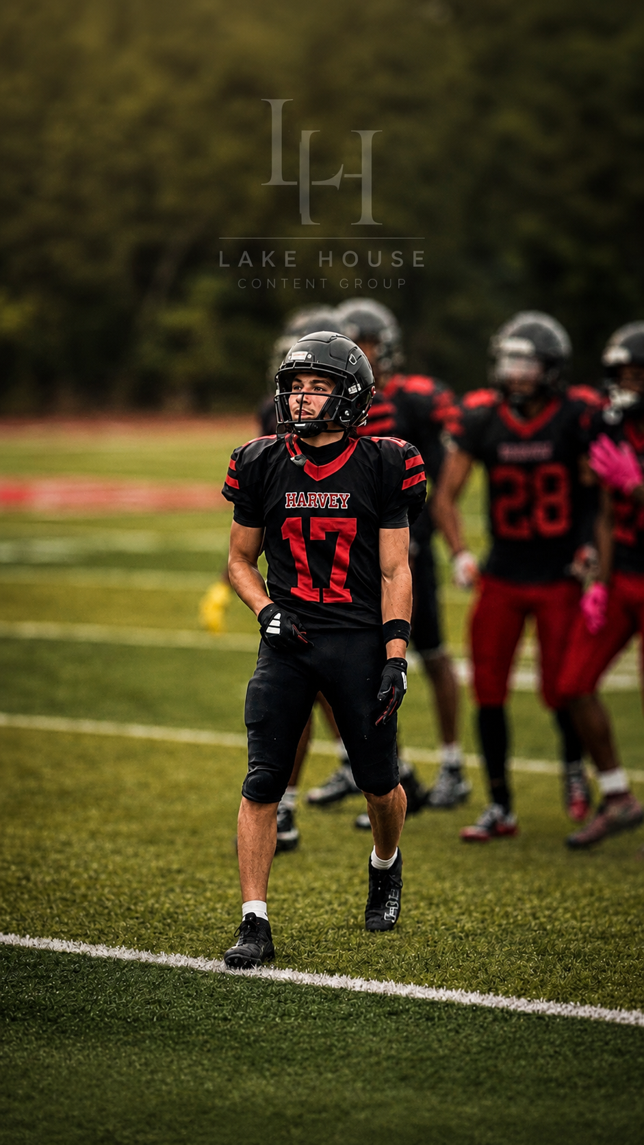 Harvey Football player photographed on the field by Lake House